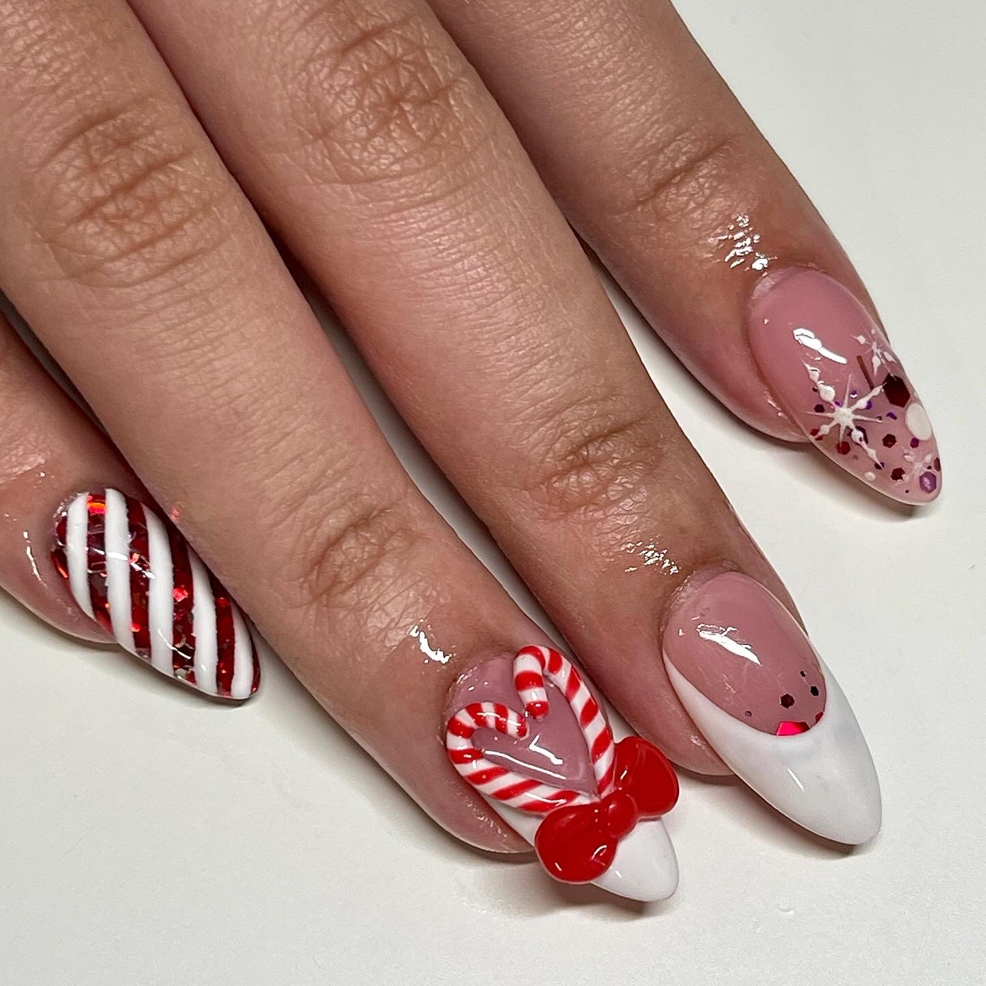 Nails with candy cane and heart designs on a white background