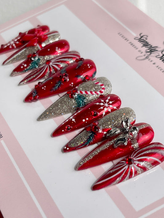 Red and silver hair clips on a pink and white background with 'Sassie' branding.