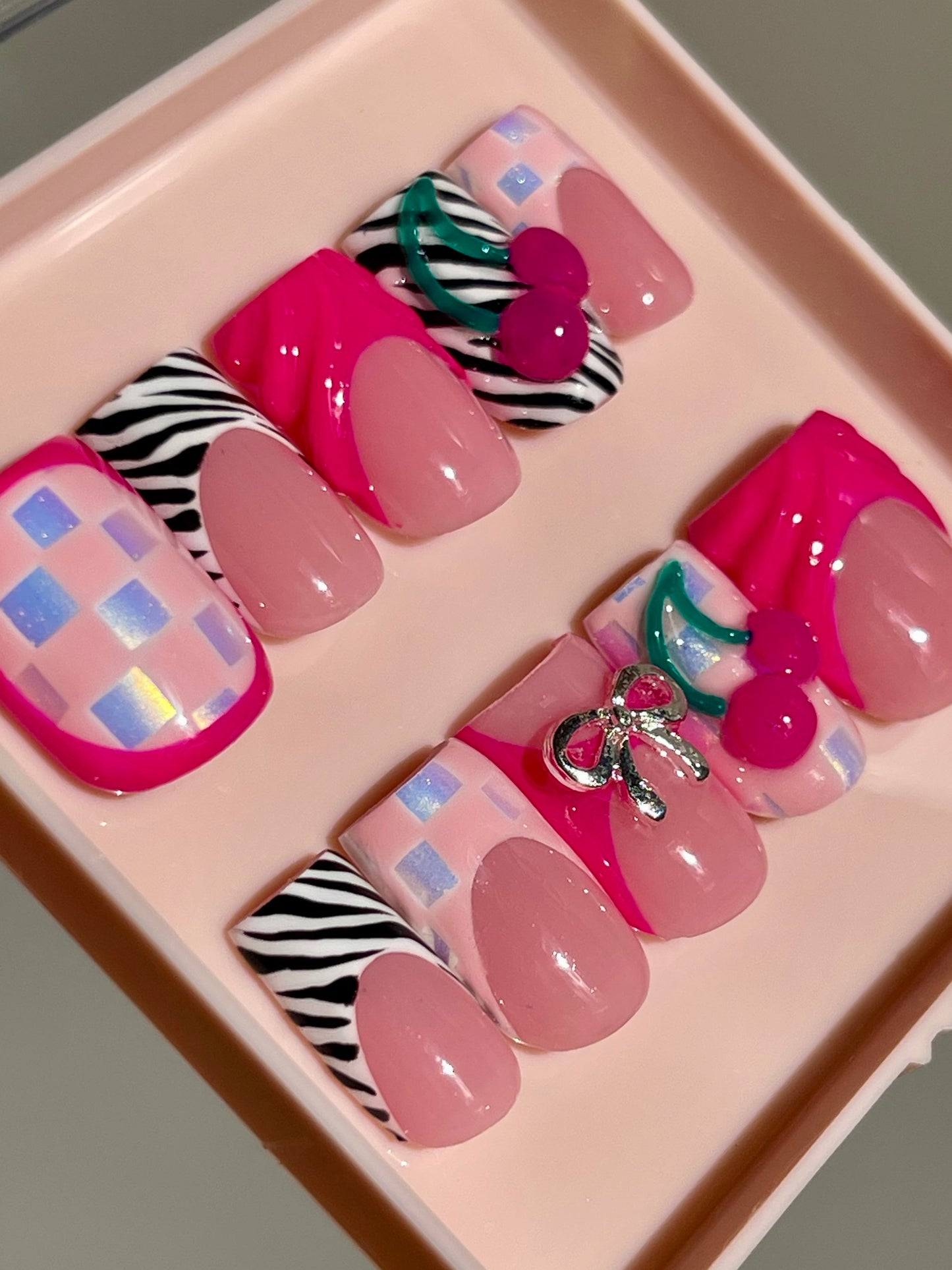Set of colorful false nails in a pink display box