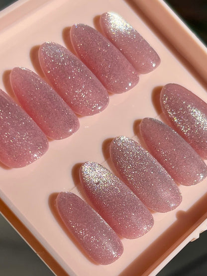Set of pink glittery false nails in a clear case