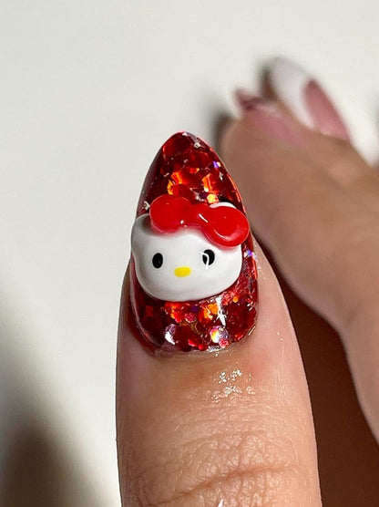 Nail art design with a Hello Kitty character on a red glittery background.