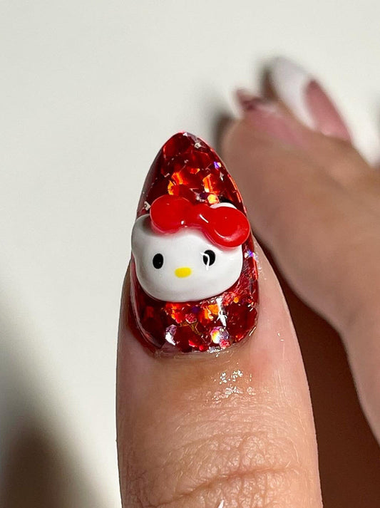 Nail art design with a Hello Kitty character on a red glittery background.