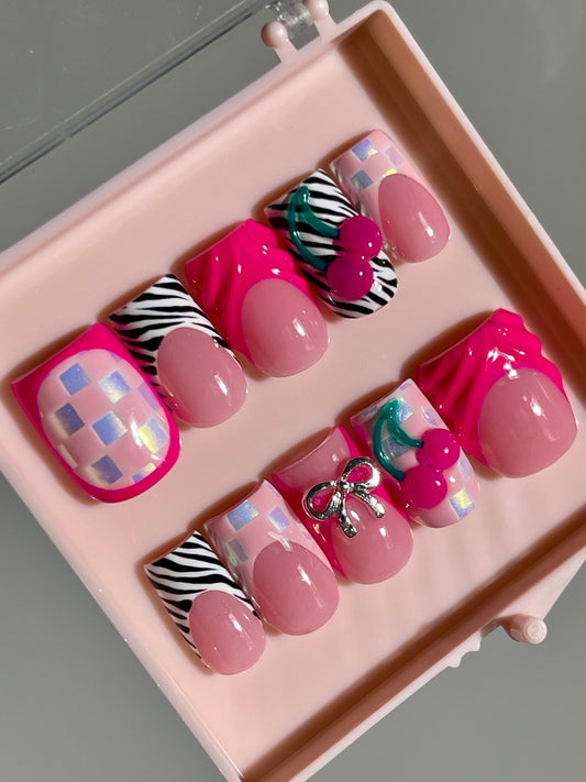 Set of pink and multicolored nail art designs in a pink case.