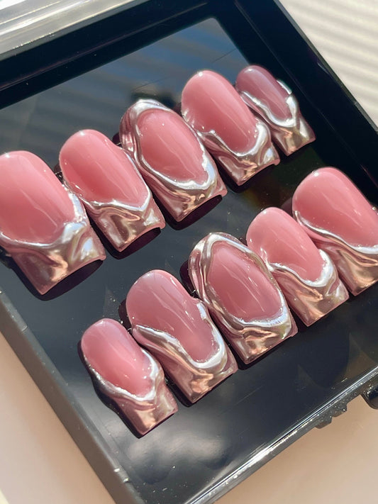 Set of pink and silver marbled nail art designs in a black case.