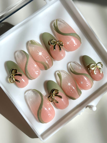 Set of decorative false nails with bow details in a white box.